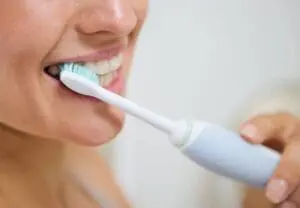 Lady brushing her teeth