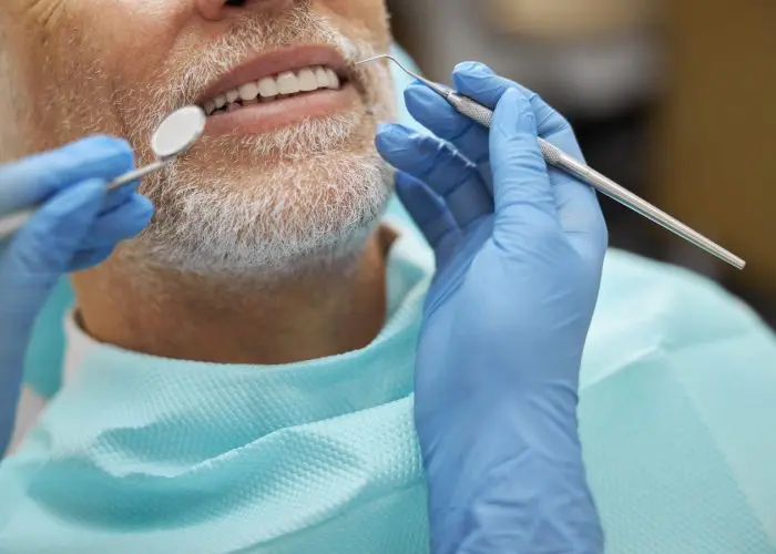 Middle-aged man getting his teeth cleaned at Byrne Dental in Rapid City
