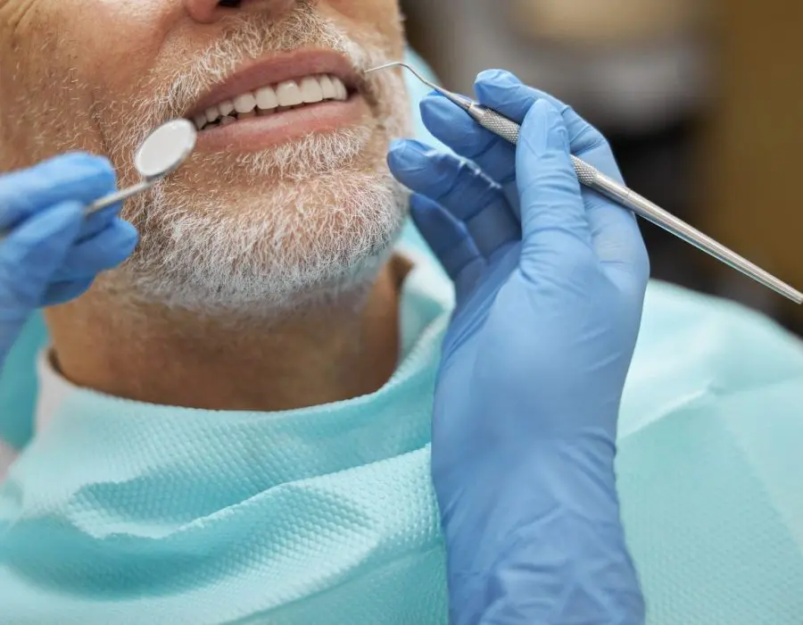 Middle-aged man getting his teeth cleaned at Byrne Dental in Rapid City