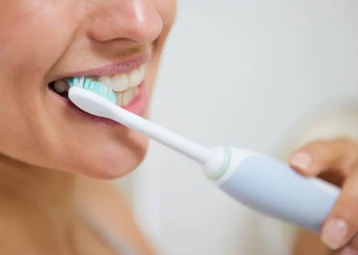 Lady brushing her teeth