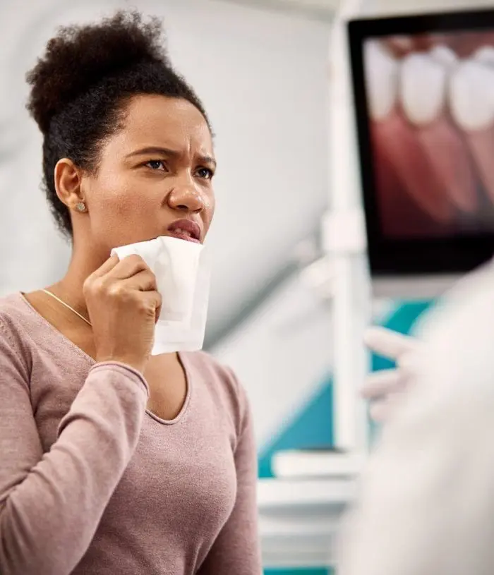 woman with tooth pain talking to Dr. Byrne