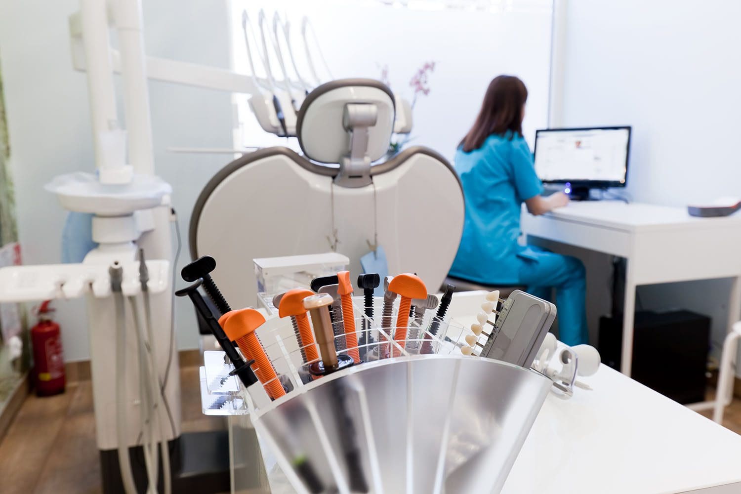 Hygienist entering doctor notes from dental appointment.