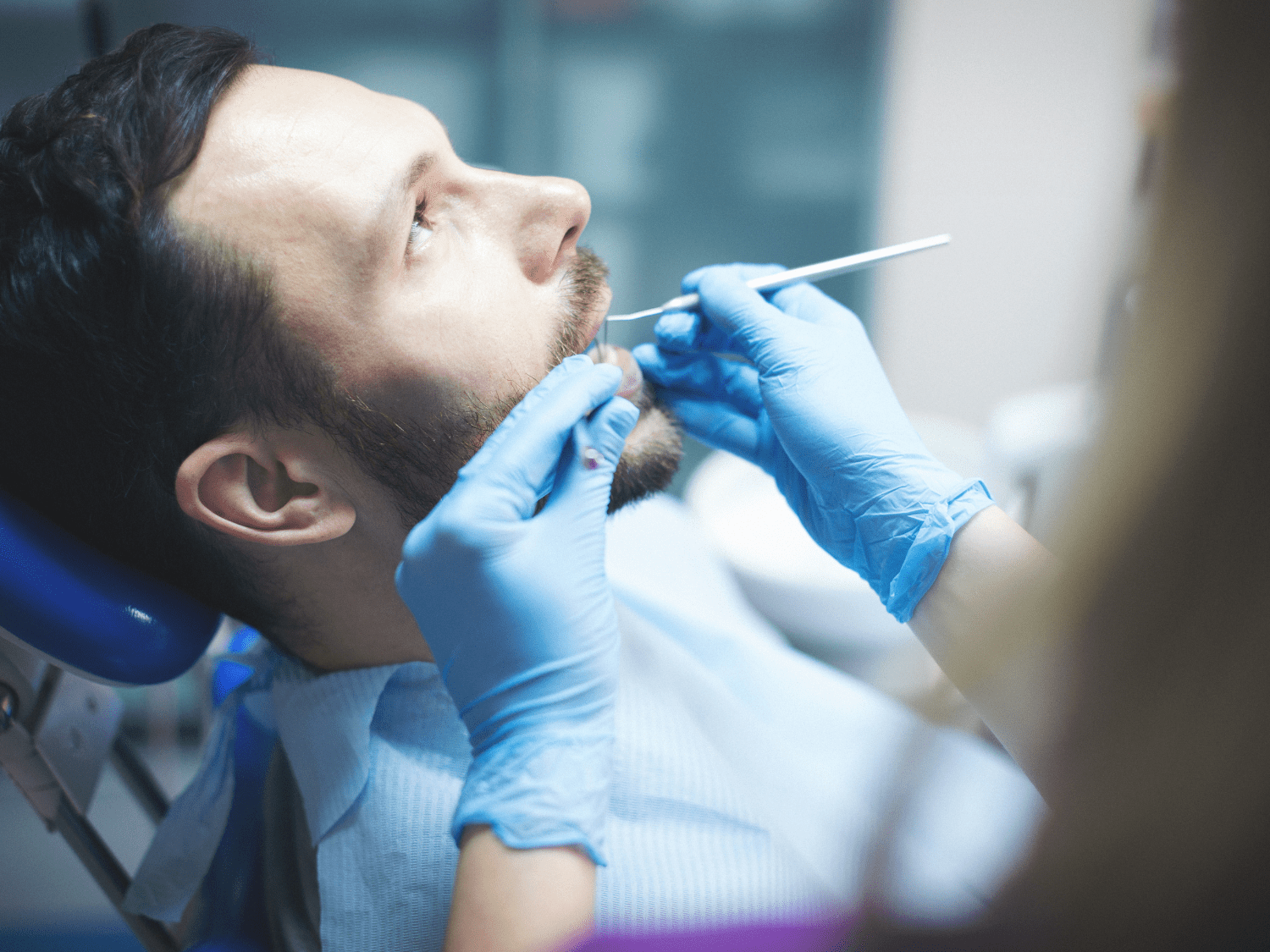 Young man getting his teeth examined by Dr. Byrne