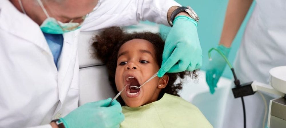 Young child at the dentist getting their gums checked for periodontal health