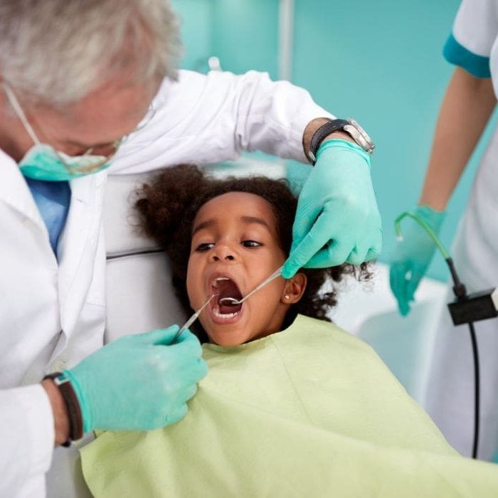 Young child at the dentist getting their gums checked for periodontal health