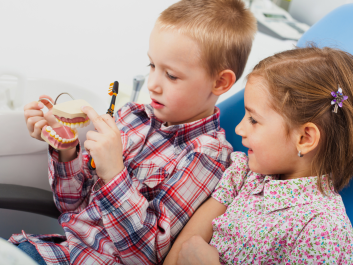 Children a the dentist getting an annual dental check up and teeth cleaning Children a the dentist getting an annual dental check up and teeth cleaning