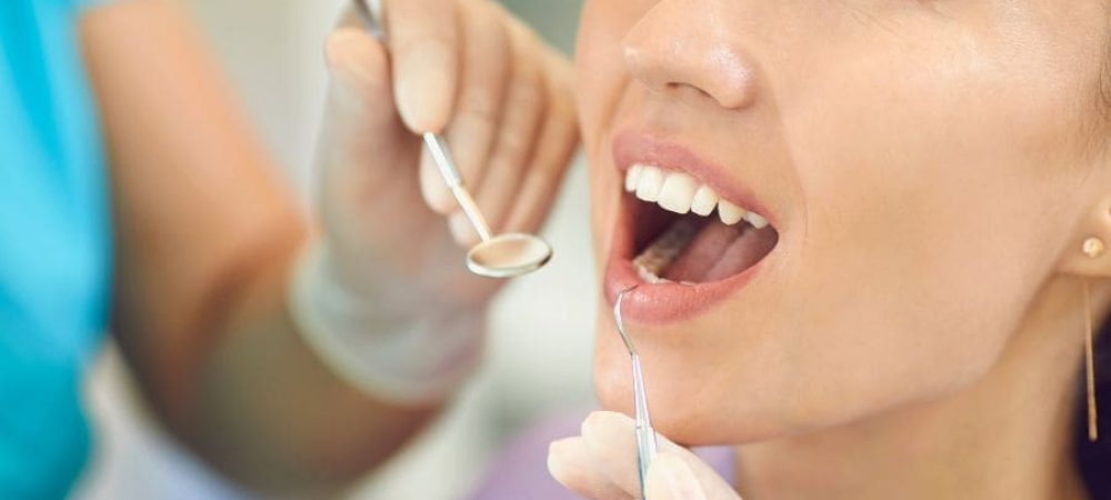 Woman at the dentist in Rapid City getting a regular checkup for a dental crown on her teeth