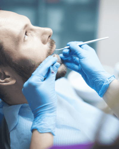 Young man getting his teeth examined by Dr. Byrne