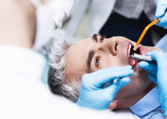 Man with root canal being treated at Rapid City dentist Man with root canal being treated at Rapid City dentist