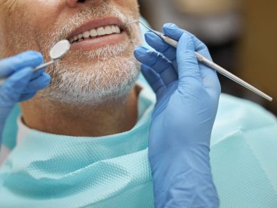 Middle-aged man getting his teeth cleaned at Byrne Dental in Rapid City