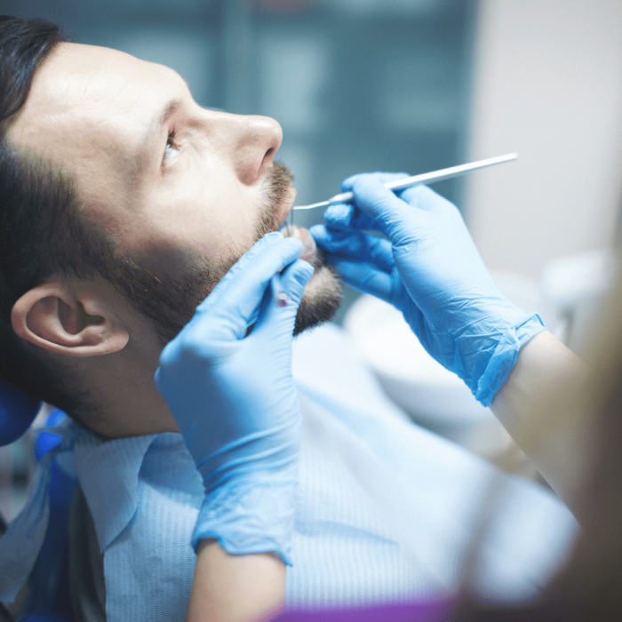Young man getting his teeth examined by Dr. Byrne